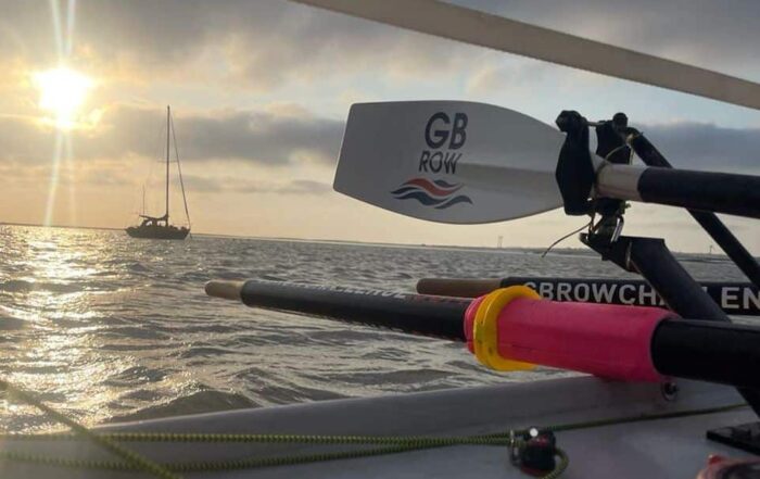 Sunset over the ocean with a rowing oar in the foreground