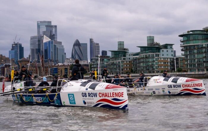 Two ocean rowing boats side by side on the Thames river