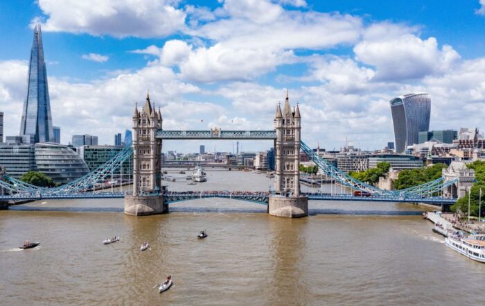 An image of Tower Bridge with three rowing boats passing underneath