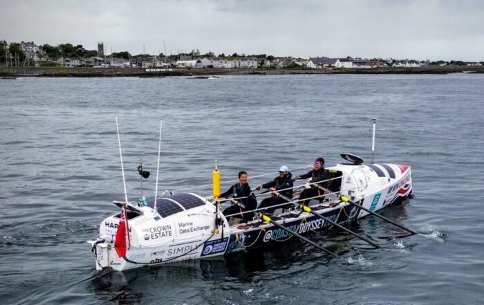 Team Coastal Odyssey rowing past Donaghadee