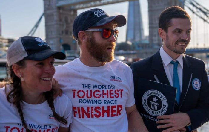 Rowers and Guinness World Record adjudicator in front of Tower Bridge, London