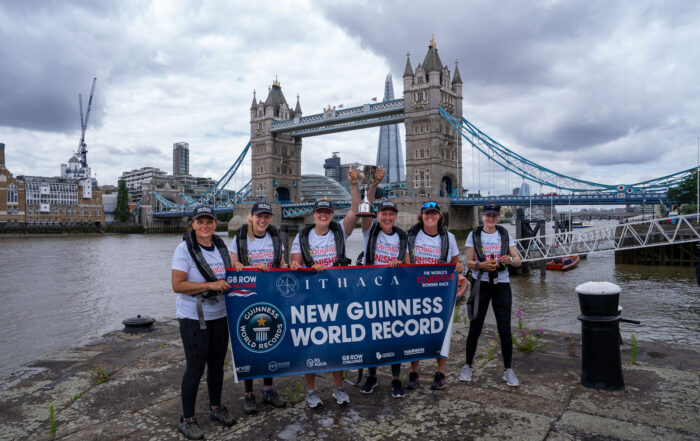 Team of rowers in front of Tower Bridge