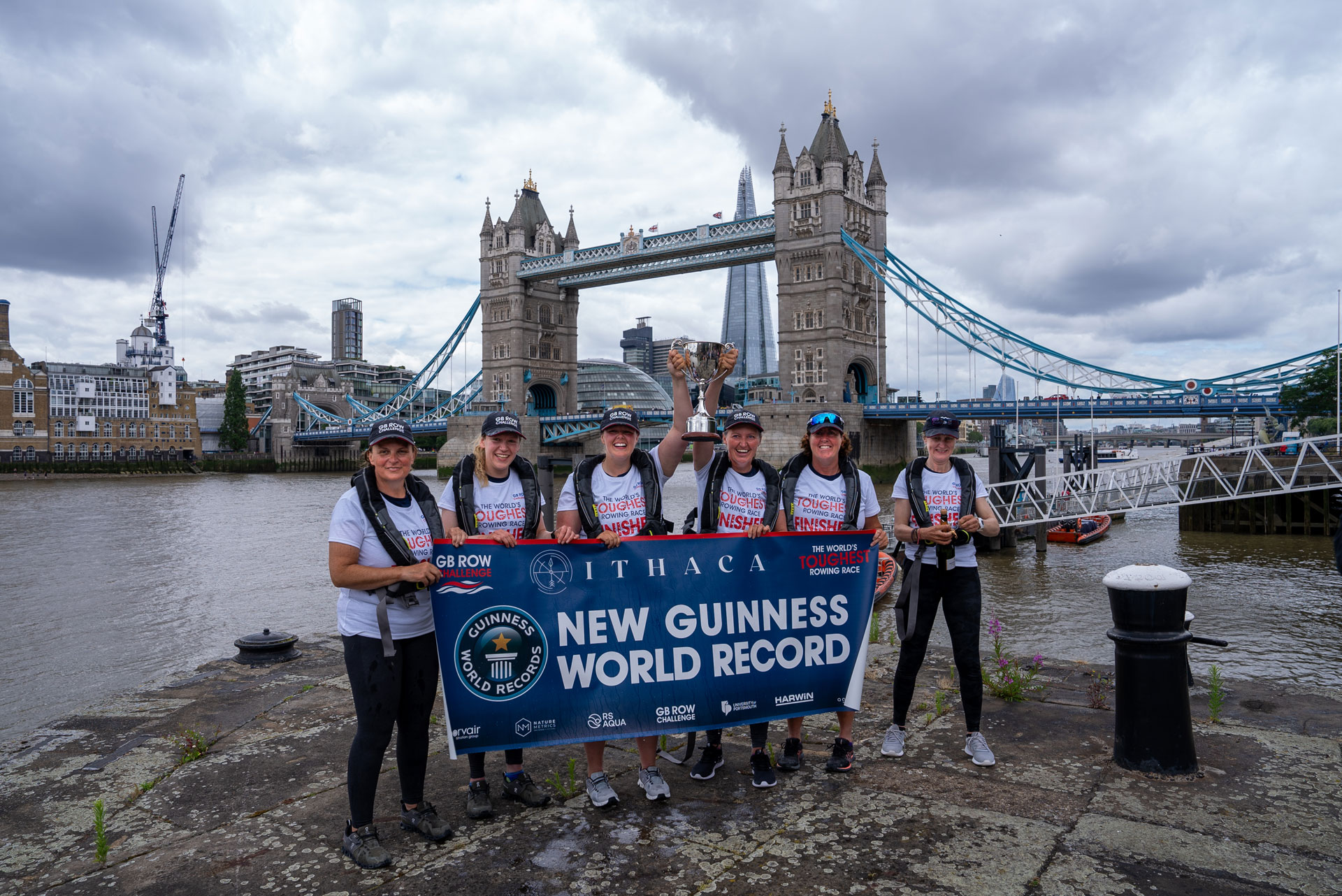 Team of rowers in front of Tower Bridge
